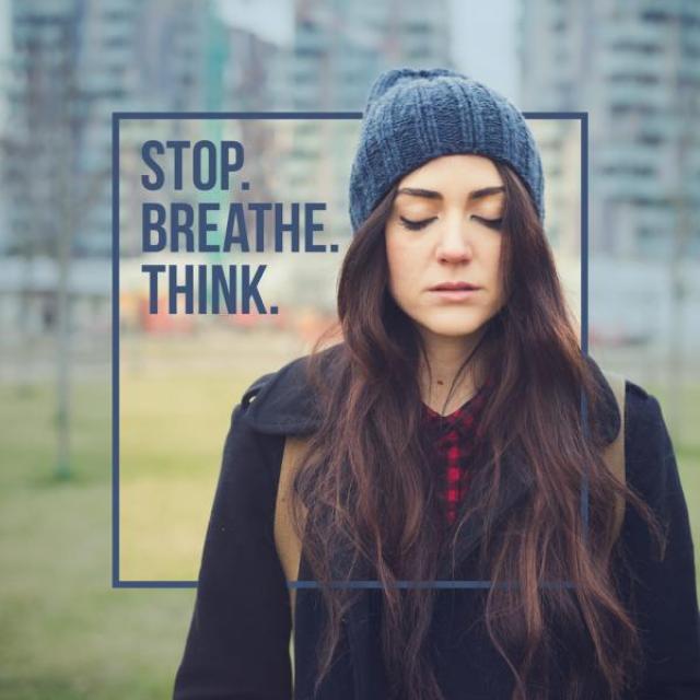 A woman in a knit hat with her eyes closed, with the caption, "Stop. Breathe. Think."